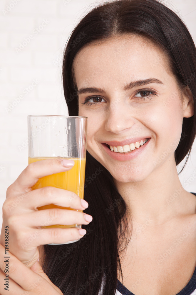 Woman drinking orange juice Beautiful mixed-race Asian, Caucasian model. Woman drinking orange juice Beautiful mixed-race Asian, Caucasian model.