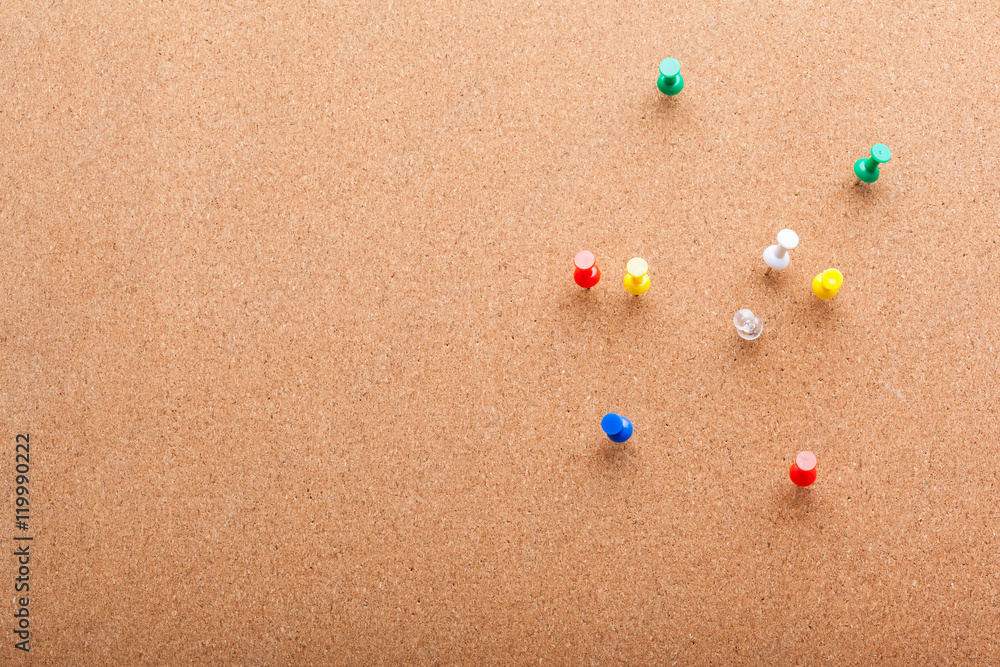 Pins on brown cork board