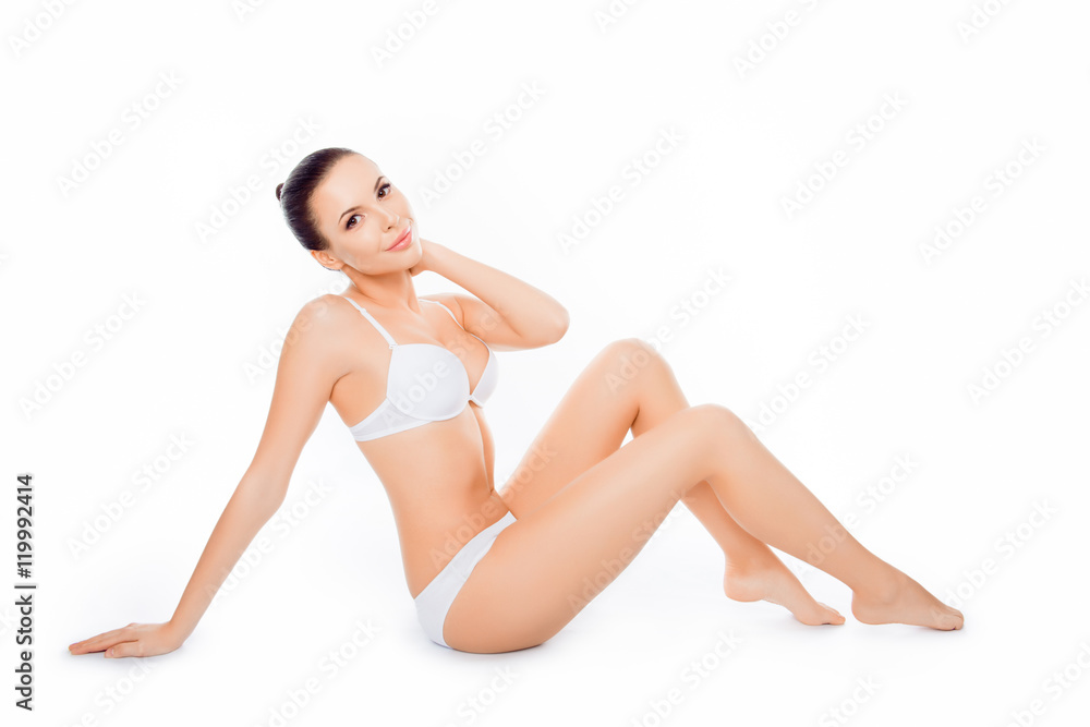Attractive sensitive  slim woman sitting in white underwear