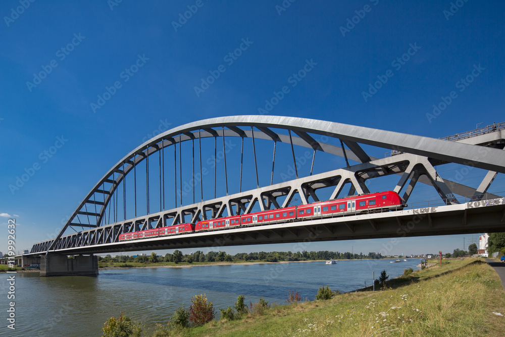 Fototapeta premium Bridge and red train over Rhein close to Dusseldorf