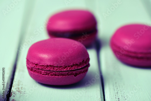 purple macarons on a pale blue rustic surface