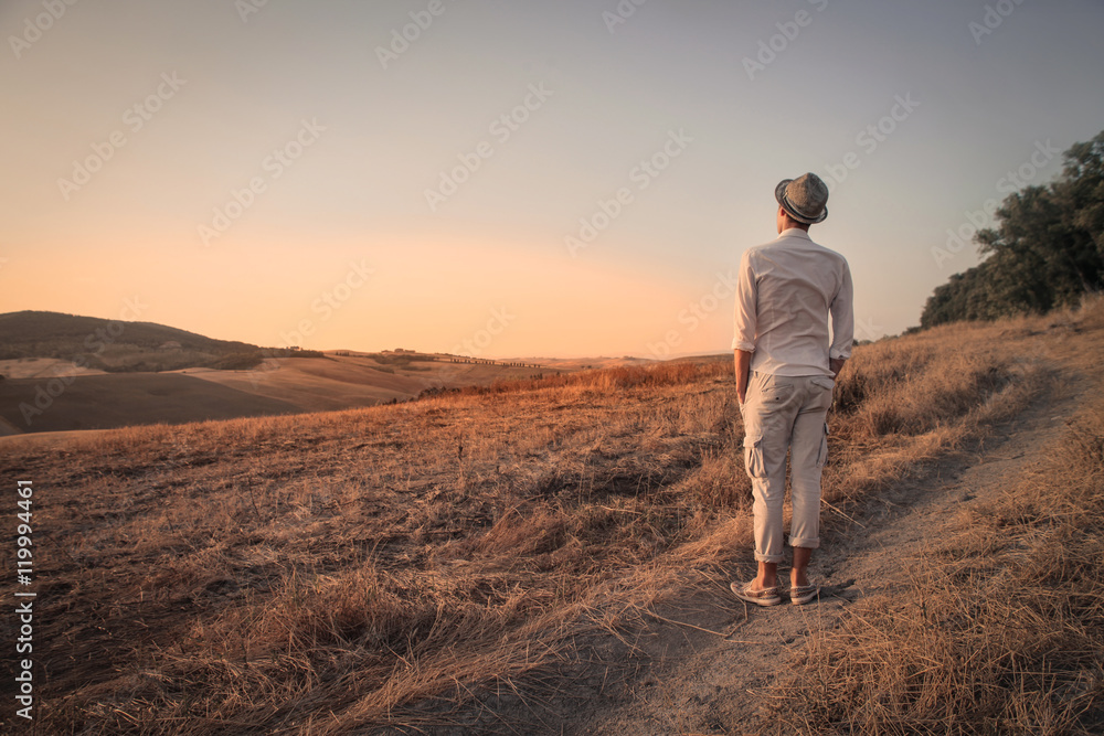 Guy admiring the panorama in the countryside