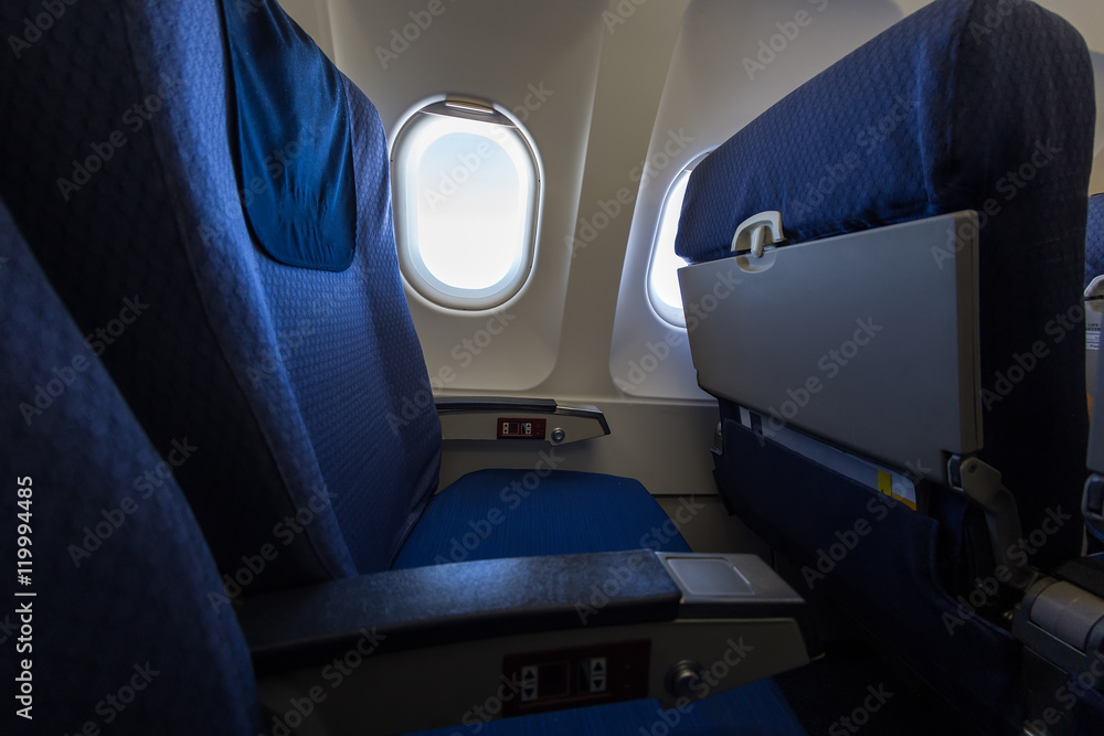 Airplane seat and window inside an aircraft.