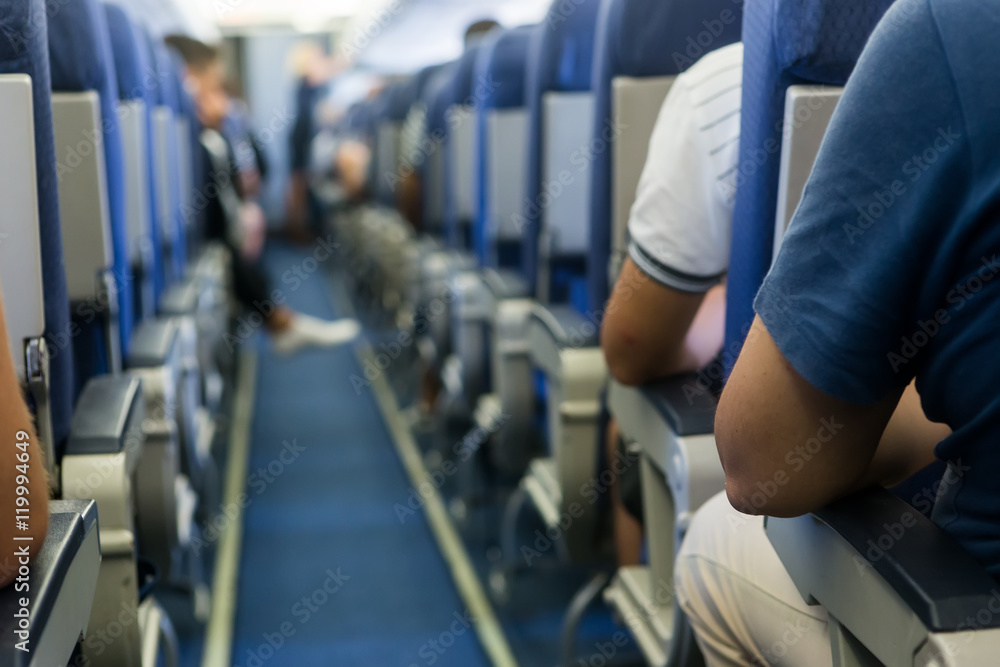 Fototapeta premium Interior of airplane with passengers on seats waiting to taik of