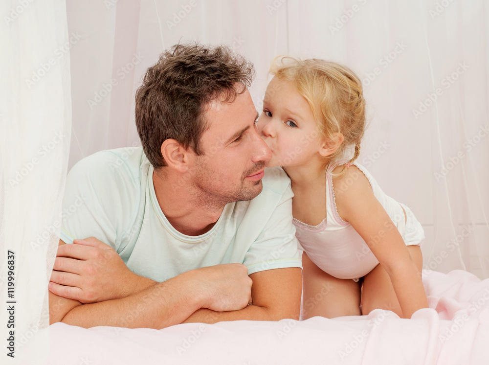 Father and daughter laughing and bonding. Daughter kissing her b Father and daughter laughing and bonding. Daughter kissing her b
