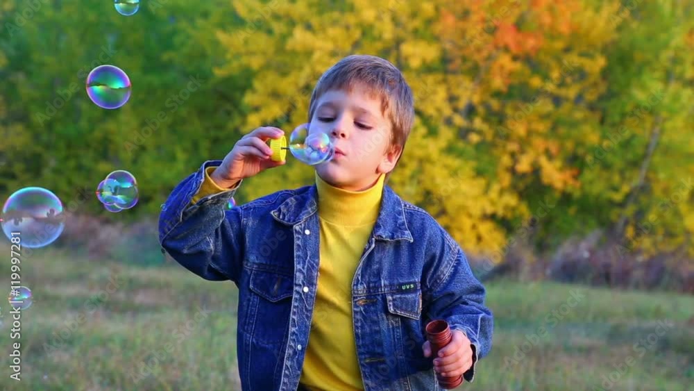 handsome boy blowing a soap bubbles handsome boy blowing a soap bubbles