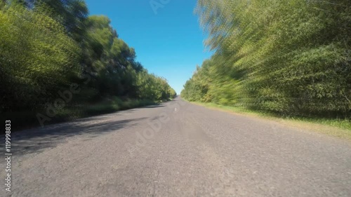 Driving a car on a country road - POV - Point of view front. Video footage of a on-board camera on a car driving along rural country lane
 photo