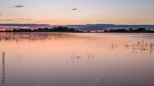 autumn pink sunset reflected in lake