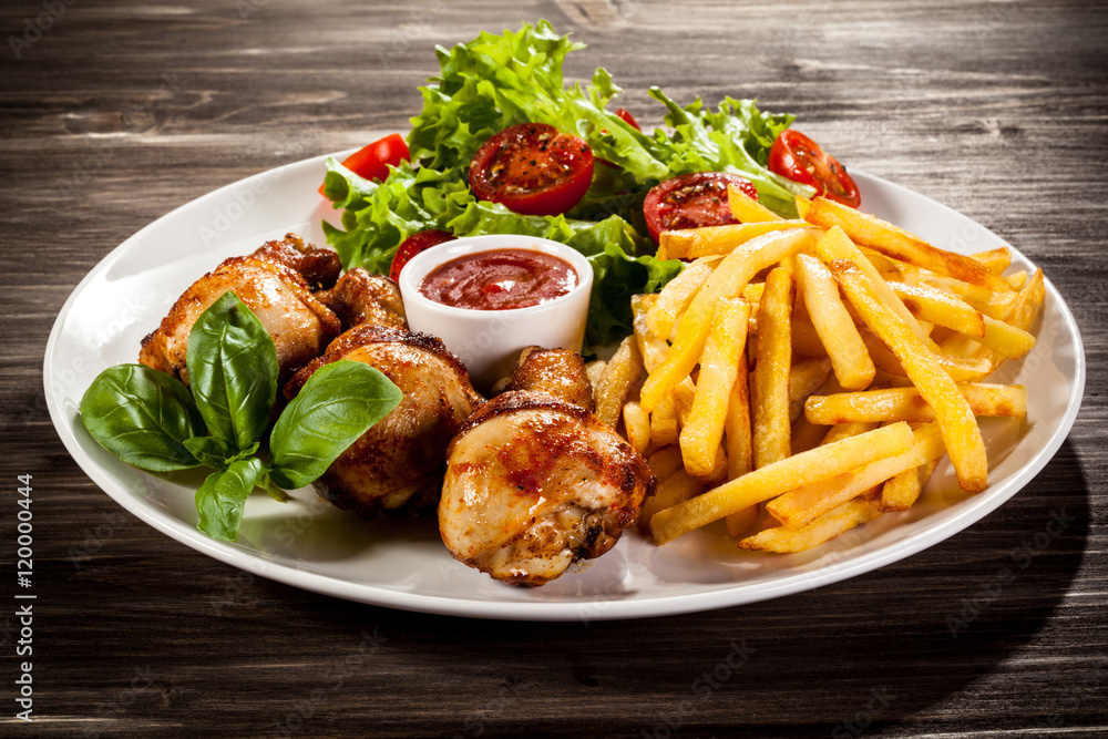 Roast chicken legs with chips and vegetables Roast chicken legs with chips and vegetables