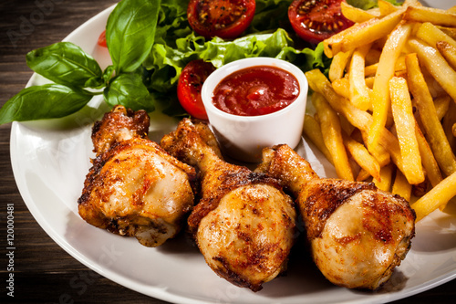 Roast chicken legs with chips and vegetables 