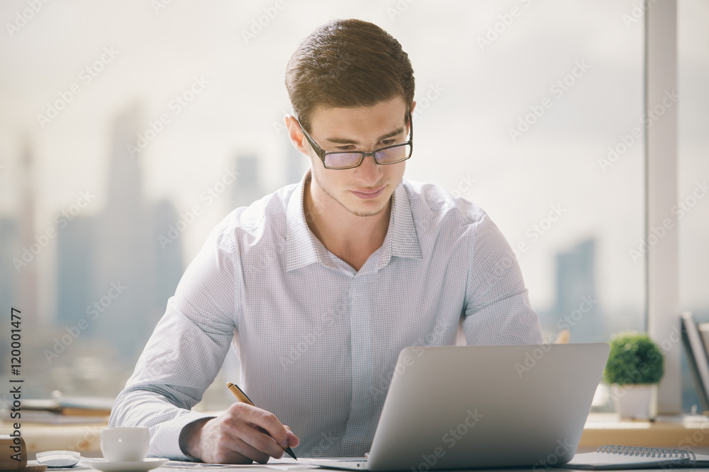 Handsome businessman working on project Handsome businessman working on project