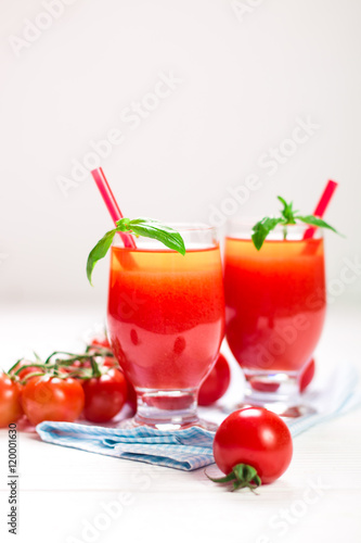 Tomato Juice and Fresh Tomatoes on a White Wooden Background