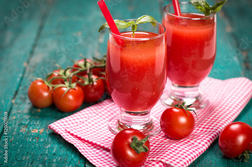 Tomato Juice and Fresh Tomatoes on a Wooden Background