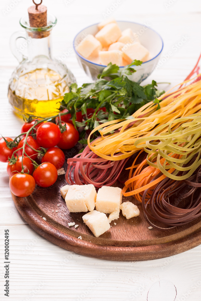 Vegetable color Pasta, oil,tomatoes,cheese on wooden table. italian food Vegetable color Pasta, oil,tomatoes,cheese on wooden table. italian food