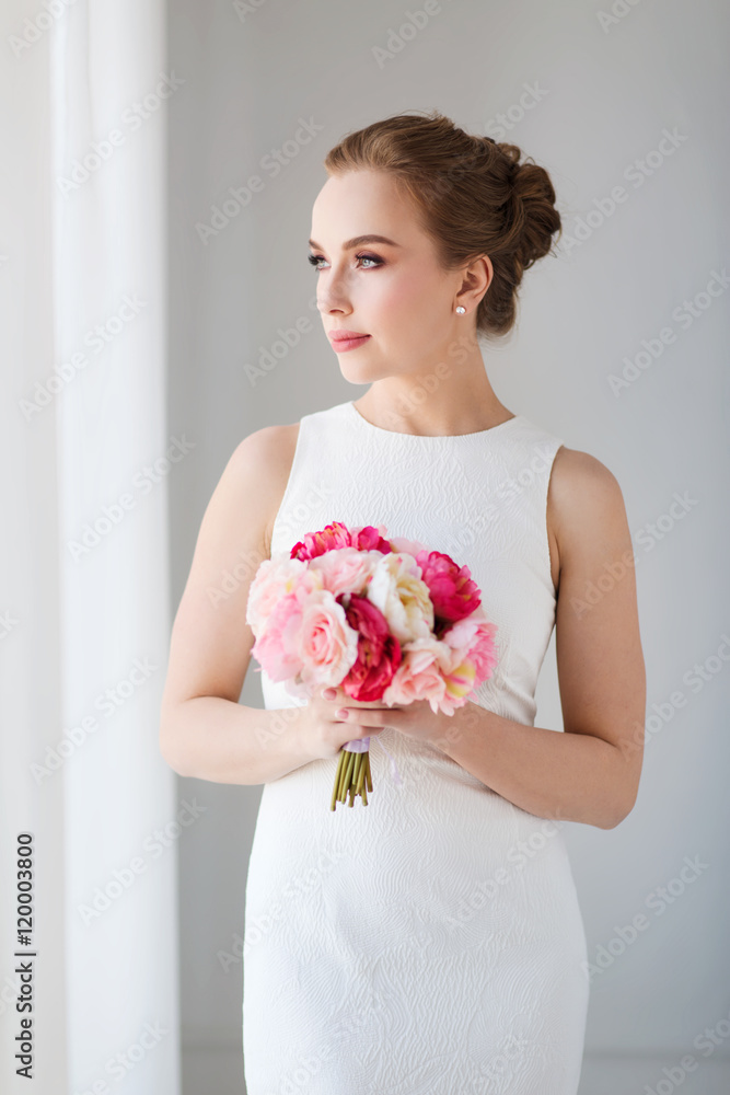 bride or woman in white dress with flower bunch