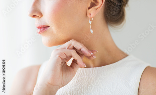Fotografija close up of beautiful woman face with gold earring