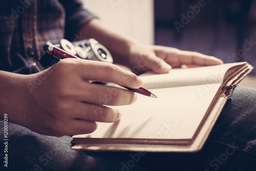 home office desk background, Desk musicians, hand holding pencil and writing note on wood table,Checklist Notice Remember Planning Concept