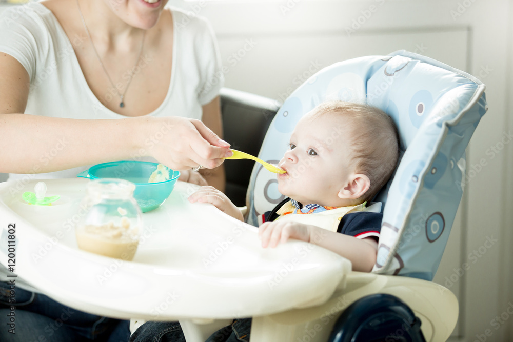 Cute 9 month baby boy eating from spoon Cute 9 month baby boy eating from spoon