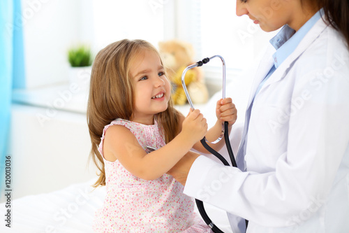 Happy little girl at health exam at doctor's office