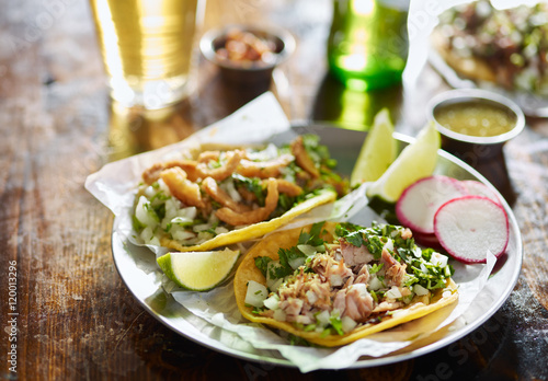 two mexican street tacos with chopped pork and Chicharrón