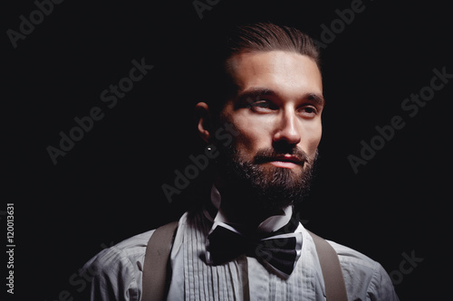 Portrait of handsome man posing for photographer in studio