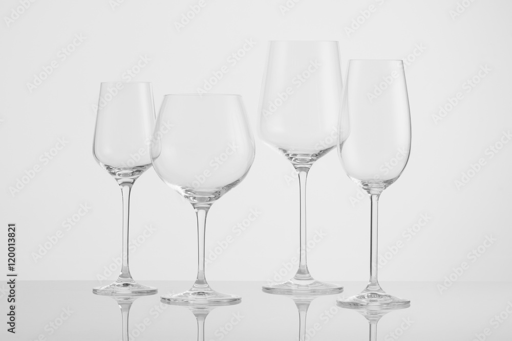several empty wine glasses on a white background