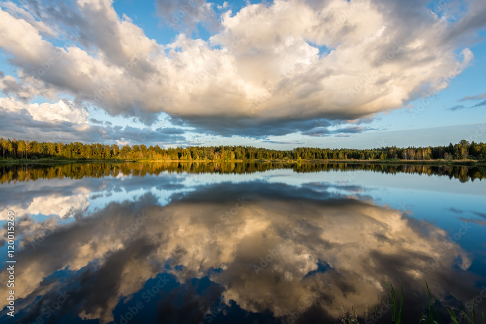 Beautiful summer sunset at the lake with blue sky, red and orang Beautiful summer sunset at the lake with blue sky, red and orang