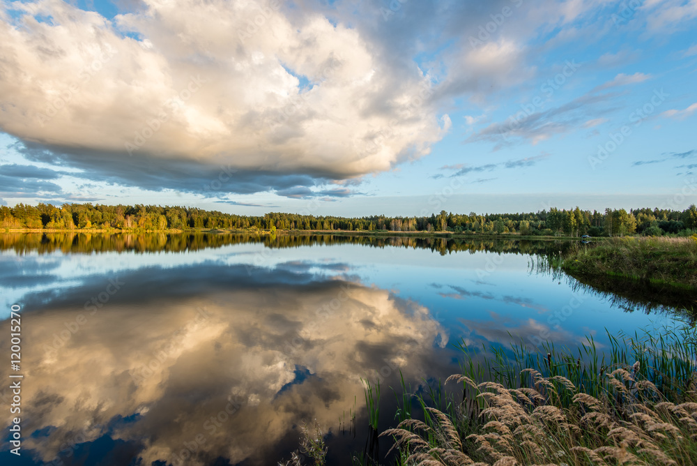 Beautiful summer sunset at the lake with blue sky, red and orang Beautiful summer sunset at the lake with blue sky, red and orang