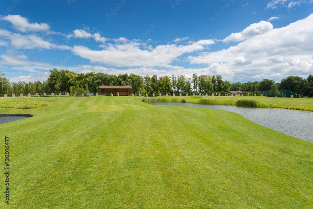 Beautiful golf course with perfect grass and water hindrance at