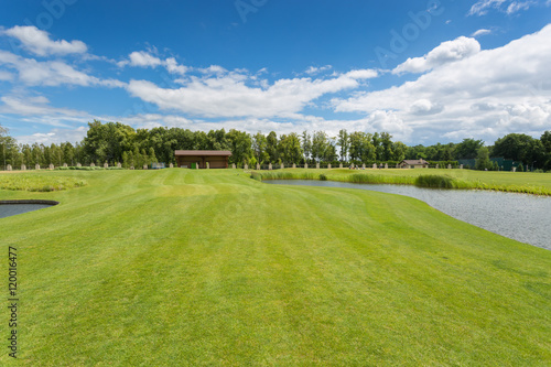 Beautiful golf course with perfect grass and water hindrance at
