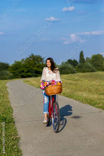 Young girl rides a bicycle photo