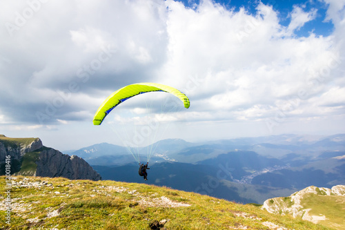 Paraglider in flight in The Carpathian Mountains, Romania, Europe. 
