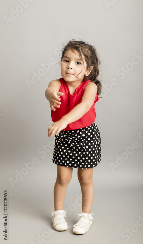 Small girl playing and posing isoated inside studio