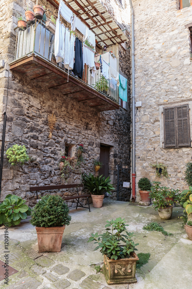 Cobbled patio with flowers in the old village Lyuseram, France