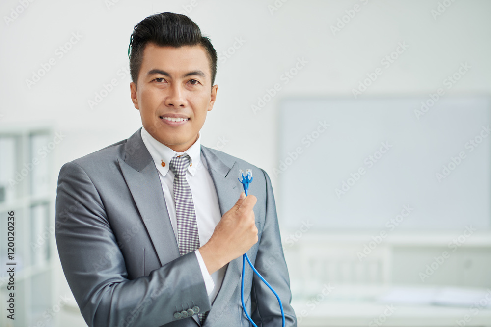 POrtrait of smiling Asian businessman holding internet cables POrtrait of smiling Asian businessman holding internet cables