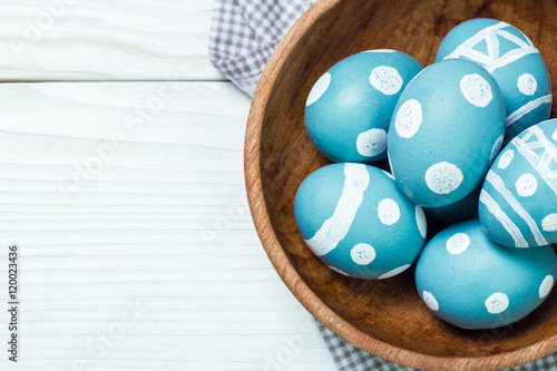 Easter concept with colored eggs on wooden background