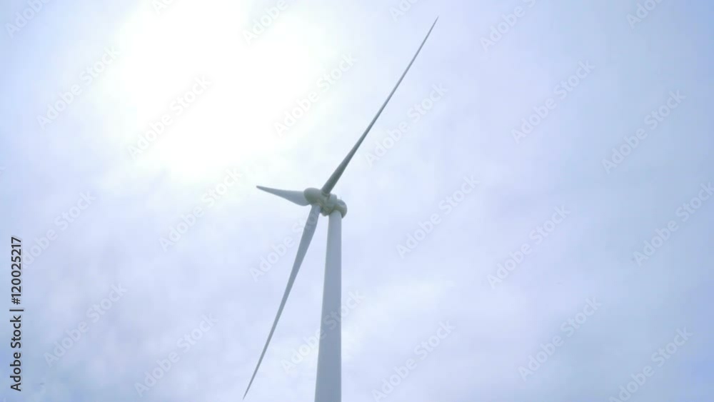 Wind turbine. Closeup of wind turbine stand on rustic road between corn fields. Wind power concept. Wind energy generator. Close up of rotating blades of wind turbine. Renewable energy source Wind turbine. Closeup of wind turbine stand on rustic road between corn fields. Wind power concept. Wind energy generator. Close up of rotating blades of wind turbine. Renewable energy source
