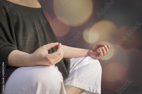 Closeup of woman's hands meditating. Yoga and meditation concept © NatasaAdzic