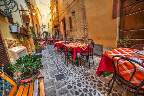 rustic tables and chairs by a trattoria photo