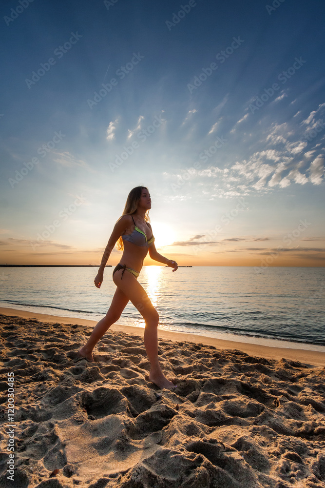 © johnqsbf - attractive sexy woman in bikini walking on sand on lonely beach on sunset sunrise © johnqsbf - attractive sexy woman in bikini walking on sand on lonely beach on sunset sunrise