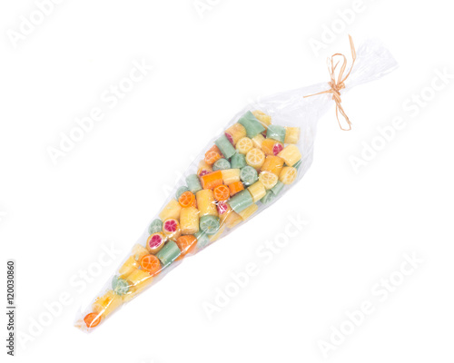 Hard home made all natural candies in skinny plastic sleeve on white background © bjphotographs