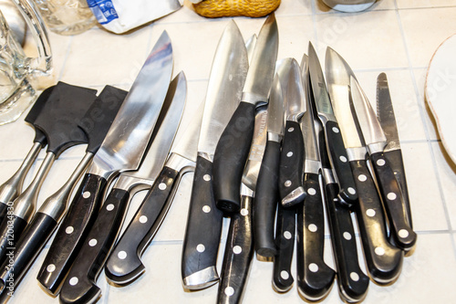 Chef's knives are on the table in the kitchen of the restaurant