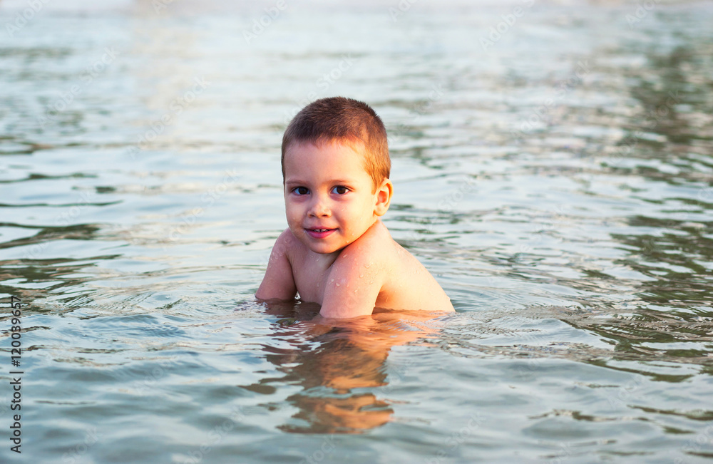 Happy child in sea water