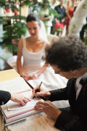  Man signing marriage papers