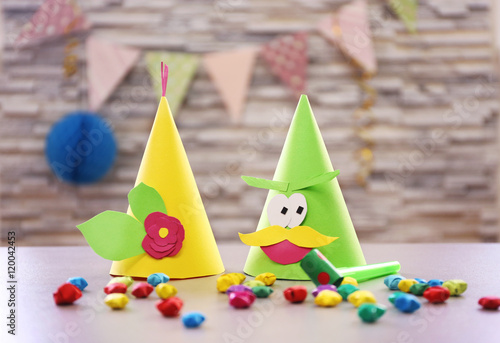 Holiday hats and decor on blurred wall background