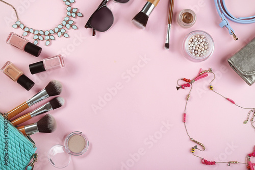 Flat lay of women cosmetics and accessories on pink background