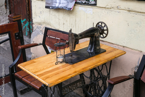 Old sewing machine Singer as a restaurant table in the Kazimierz Jewish district of Krakow. 