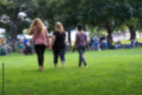 blur background of people walking through park