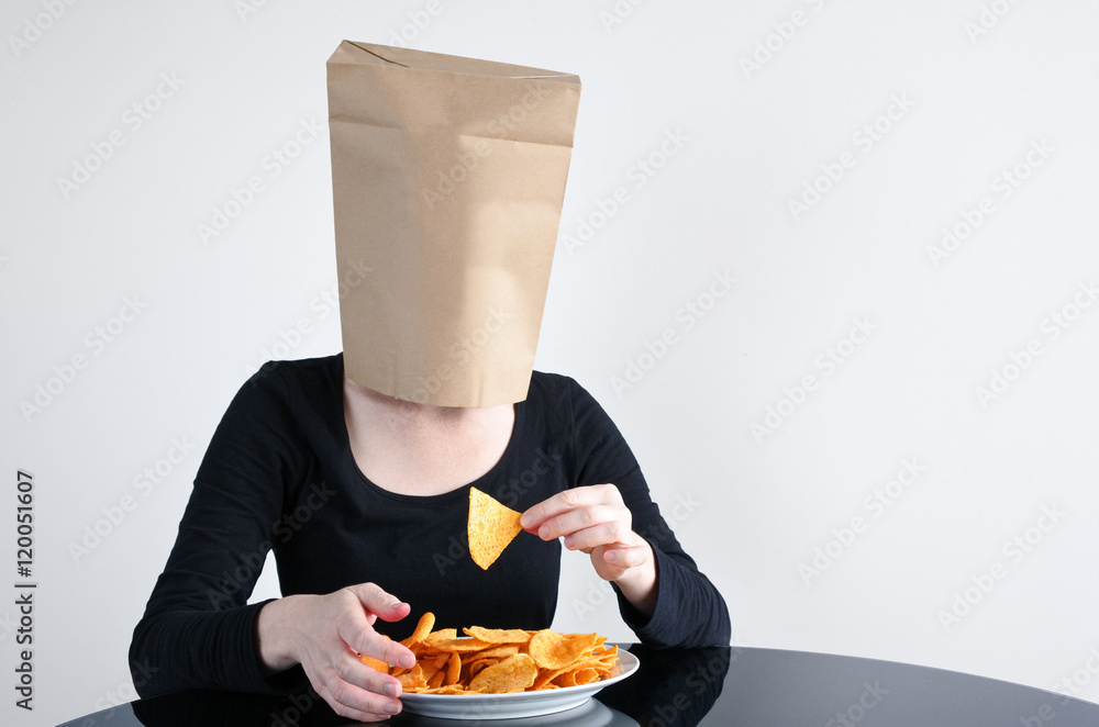 Anonymous woman blindly eats unhealthy food Anonymous woman blindly eats unhealthy food