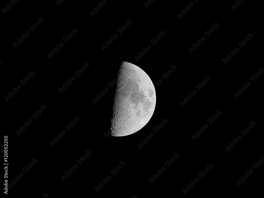 Half moon, isolated on black background for design. Black and white photo with high detailed surface (mares, craters, ridges). Half moon, isolated on black background for design. Black and white photo with high detailed surface (mares, craters, ridges).